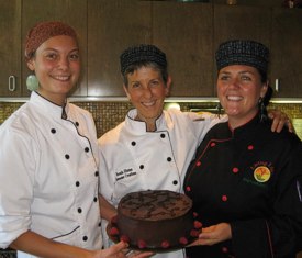 Brenda shows off her German Chocolate Cake (secret ingredient: zucchini) with assistants Meagan and Amber